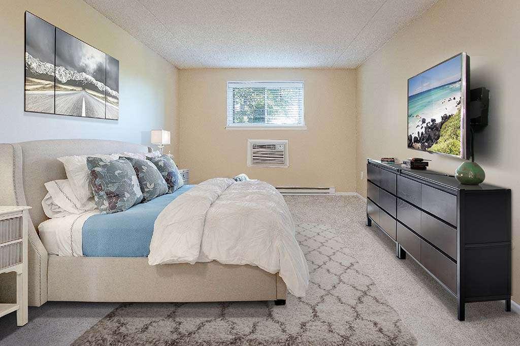 Decorated and fully furnished bedroom with a TV at The Park at Westminster apartments for rent