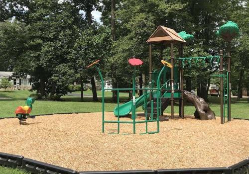 Playground with a green slide near The Park at Westminster apartments for rent in Warrington, PA