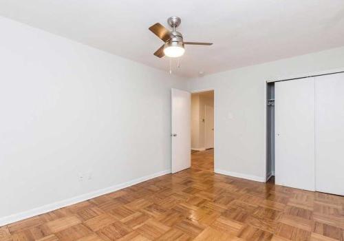Bedroom with ample closet space, hardwood floors, and ceiling fan at Sedgwick Terrace apartments.